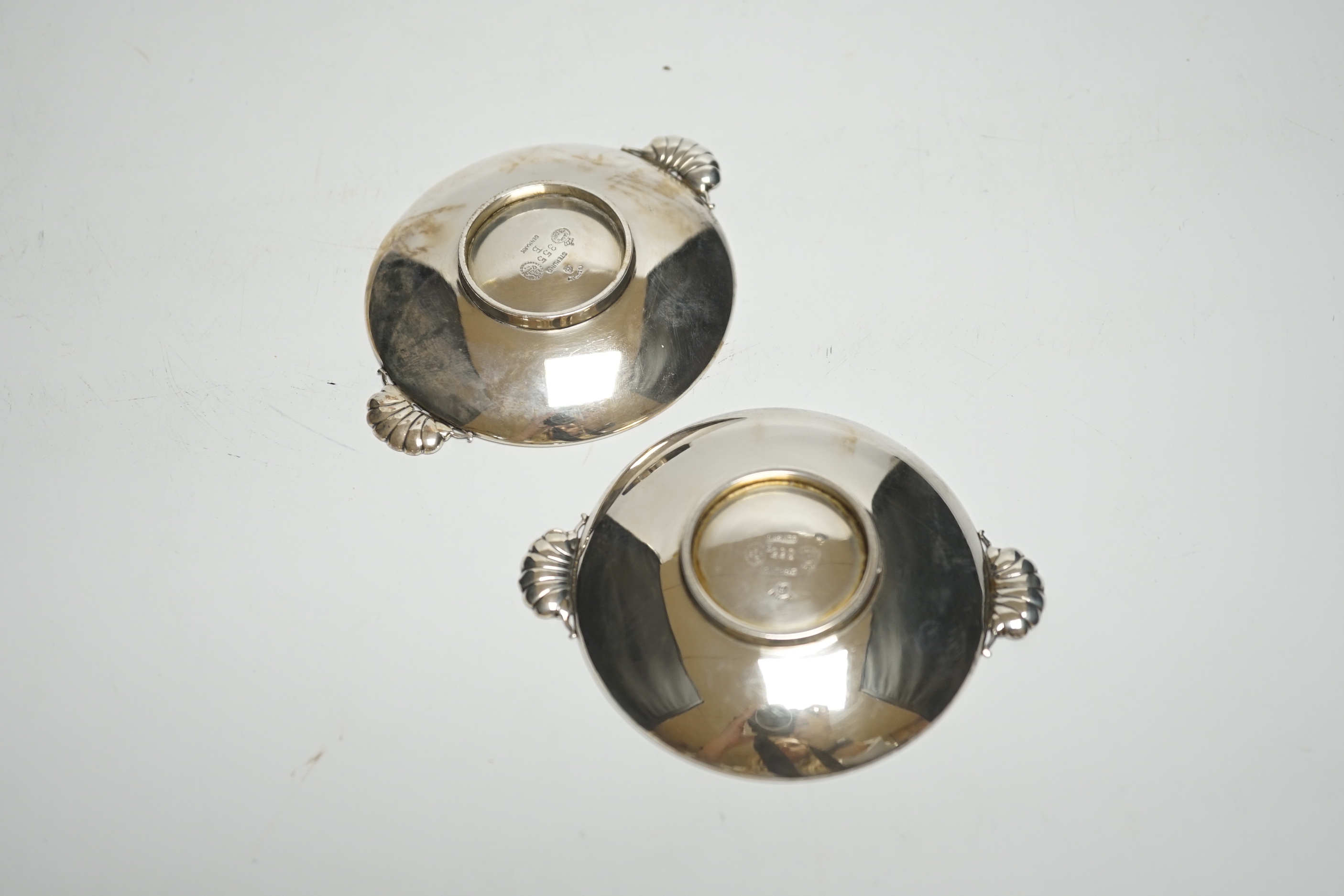 A pair of small 1930's Georg Jensen sterling dishes, with fluted lug handles, 94mm.